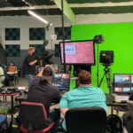 Production crew managing lighting and cameras during a live show at JDS Creative Academy.